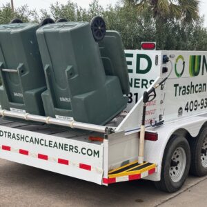 A trailer loaded with green trash bins for waste collection.